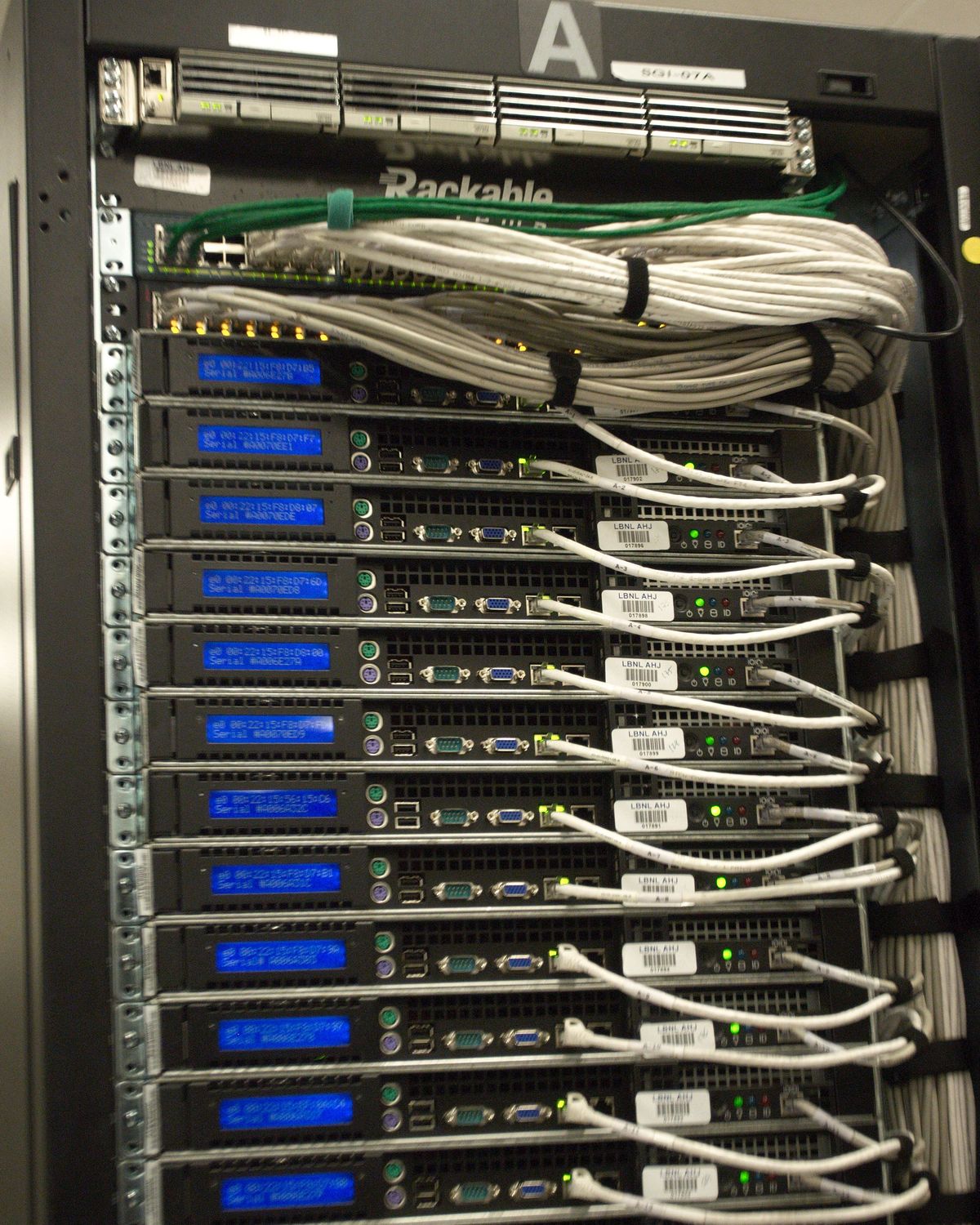 Close-up of the rear of a server rack with network cabling and status displays